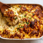 salsa verde chicken and rice bake in a white ceramic dish with golden melted cheese, top-down view